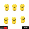 A pack of six vibrant yellow smiley face adhesive hooks for wall organization.
