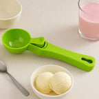 Ergonomic green ice cream scoop with non-stick design.