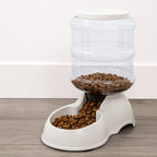 White automatic pet food dispenser with clear food storage bottle for dry kibble
