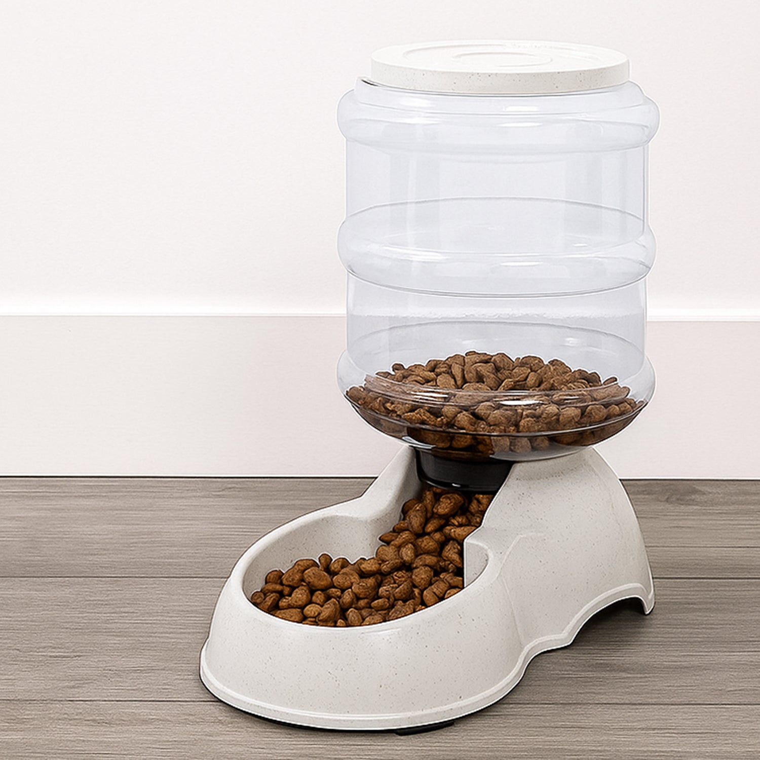 White automatic pet food dispenser with clear food storage bottle for dry kibble