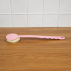 Velvet Wipe back scrubber demonstrating its extended handle for full back coverage during bathing.