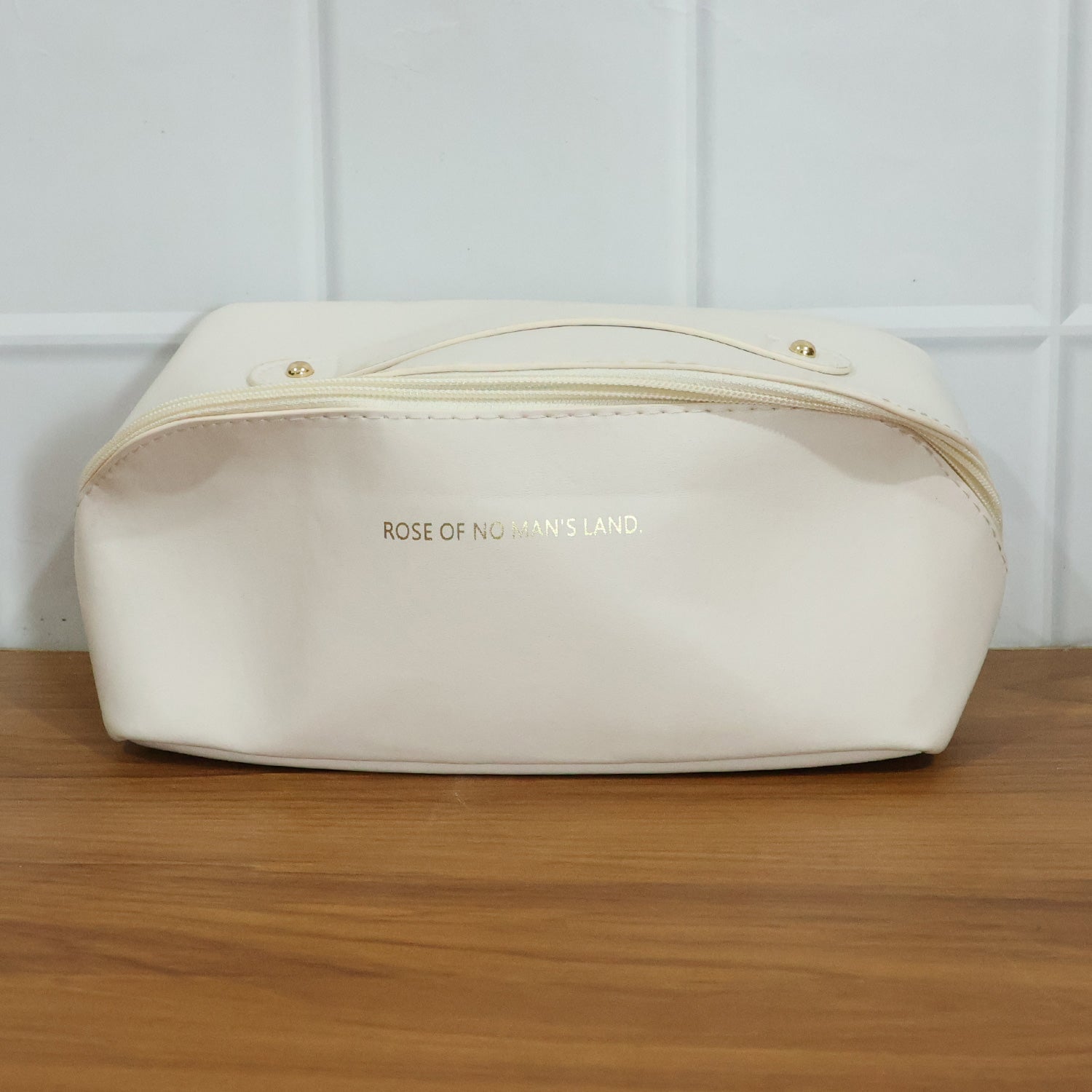 Open travel organizer pouch displaying internal compartments for toiletries
