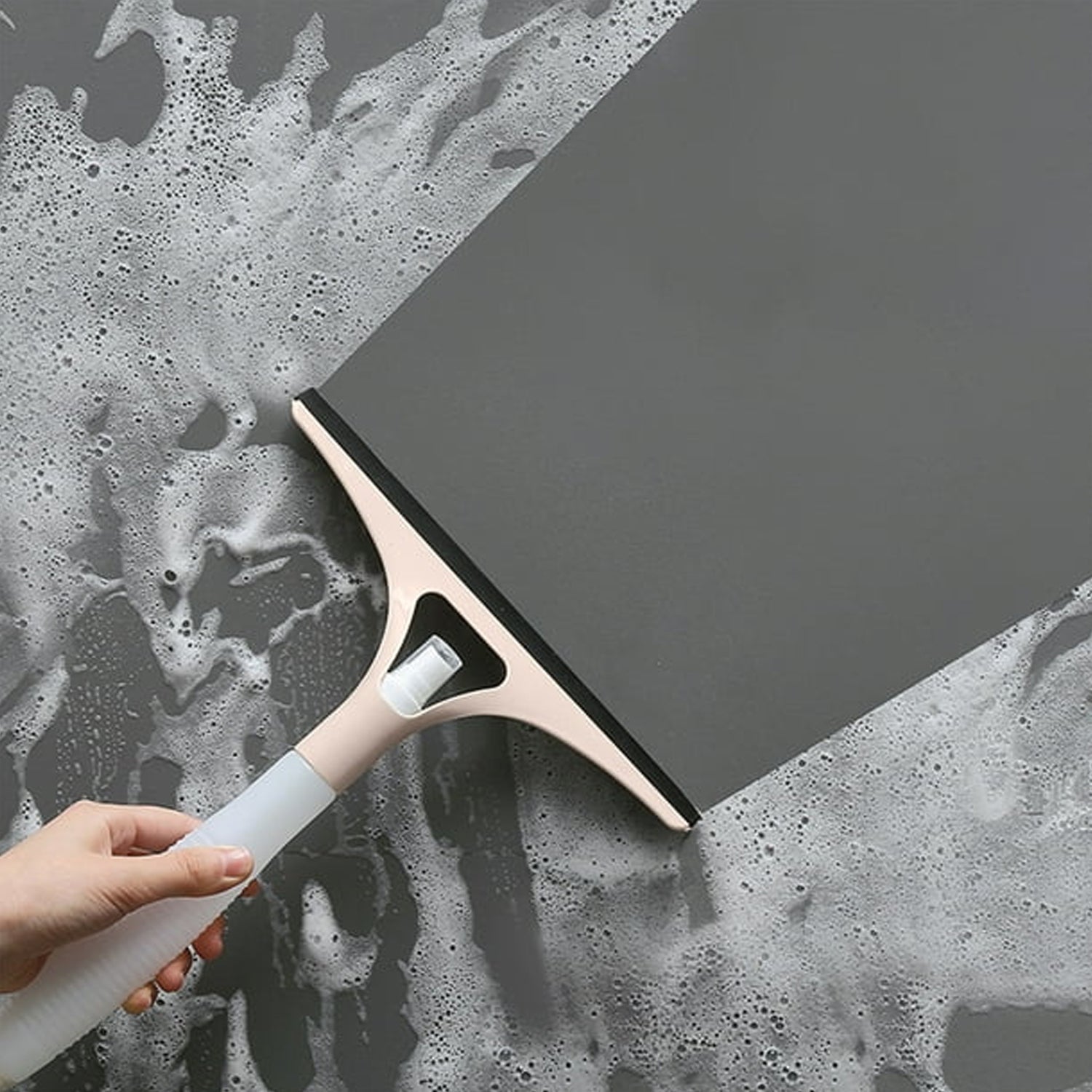 Detaching the refillable spray bottle from the cleaning brush for easy refill.
