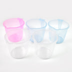Ergonomic handle design on a transparent plastic bathing mug for easy grip.