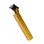 The electric trimmer shown with its cleaning brush and lubricating oil for maintenance.