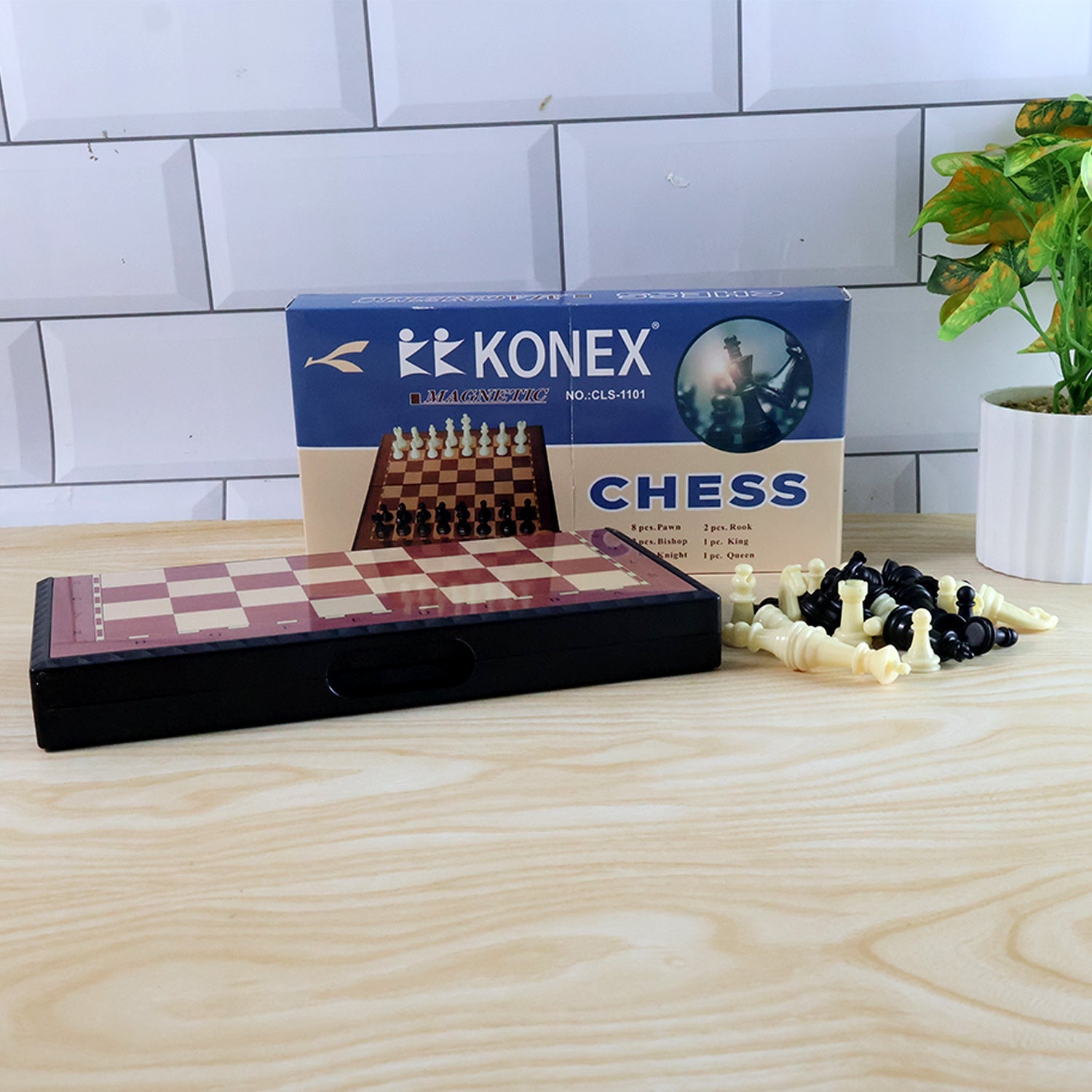 Foldable chess board displaying magnetic plastic pieces in play