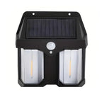 Solar wall light shown to scale on a brick wall, highlighting its compact size.