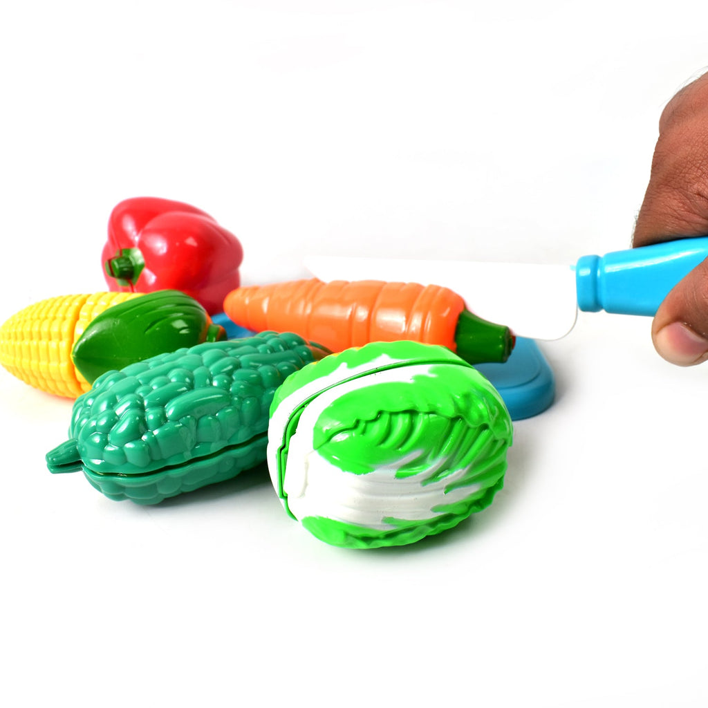 Toy apple and bell pepper from the Slice & Play Toy Set, cut into two halves.