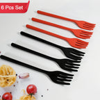 Silicone cooking forks displayed on a kitchen counter, showing the integrated stand keeping the head off the surface.