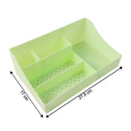 Workspace with green desk organizer storage tray and stationery inside
