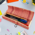 Handcrafted bamboo mat style pen and pencil box on a wooden surface