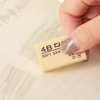 Yellow 4B erasers arranged in an aesthetic pattern, highlighting their uniform size.