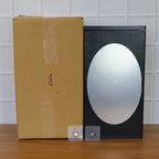 Stylish black wall-mounted storage box with front oval mirror for grooming essentials