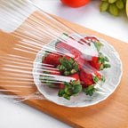 Multiple disposable elastic food covers in various sizes shown ready for use.
