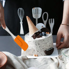 Silicone brush and spatula tools shown in use for mixing cake batter.