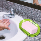 An empty wall-mounted plastic soap dish holder, ready for use.