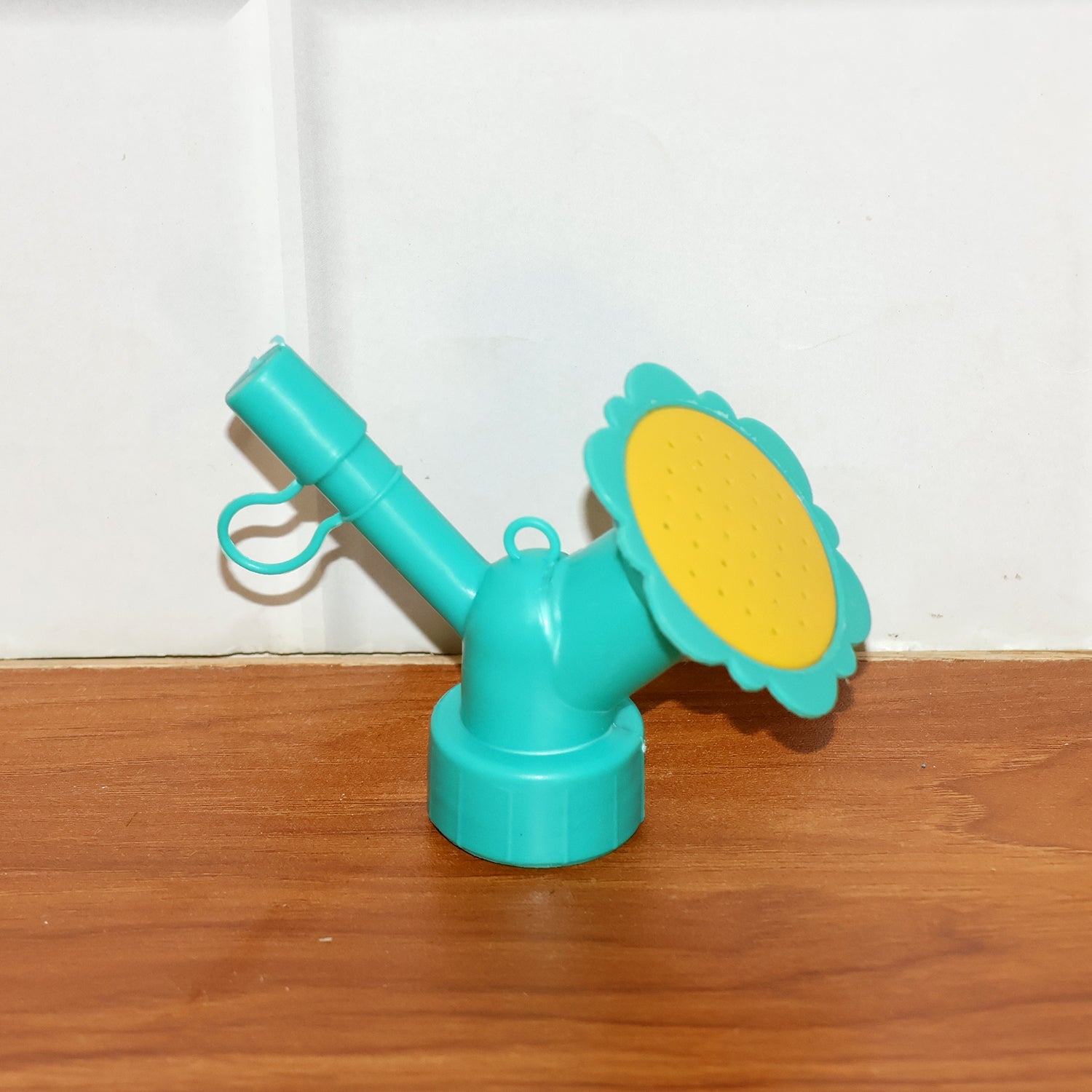 Bottle sprinkler head nozzle showing compact, portable gardening accessory
