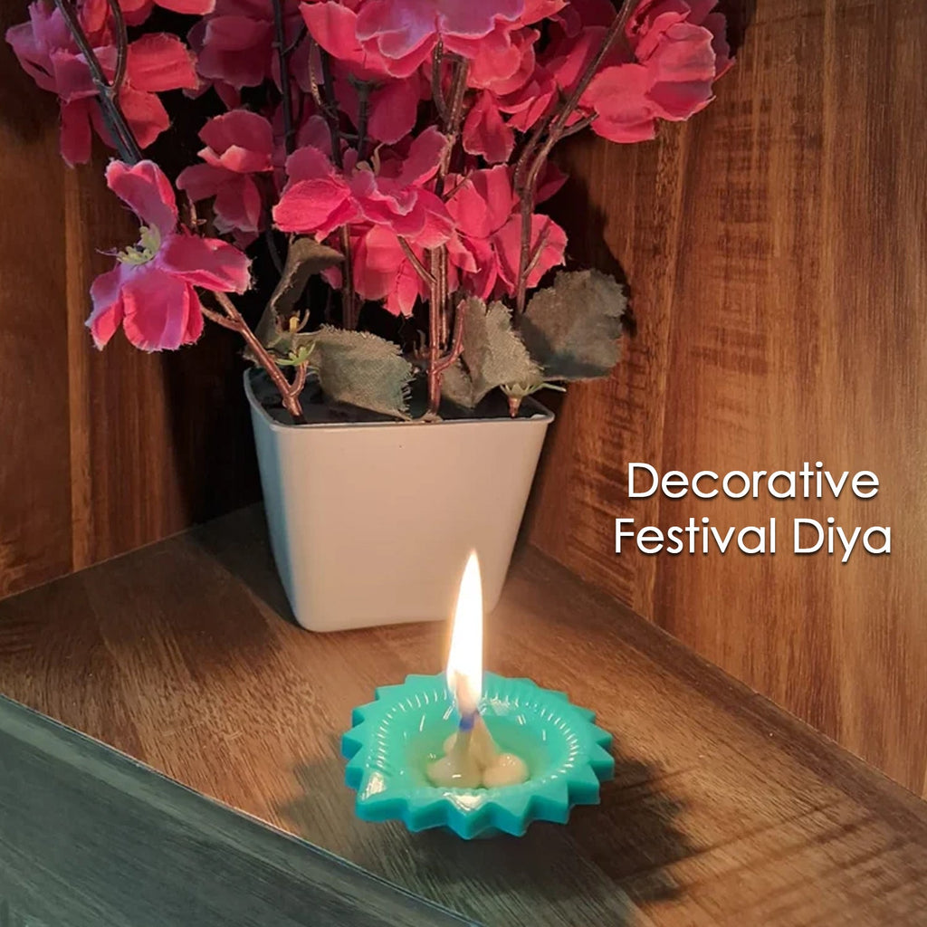 A hand gently places a colourful silicone diya for traditional Diwali decoration.