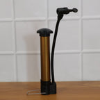 Side view of the Mini Hand Air Pump inflator with its needle securely attached, ready for inflation.