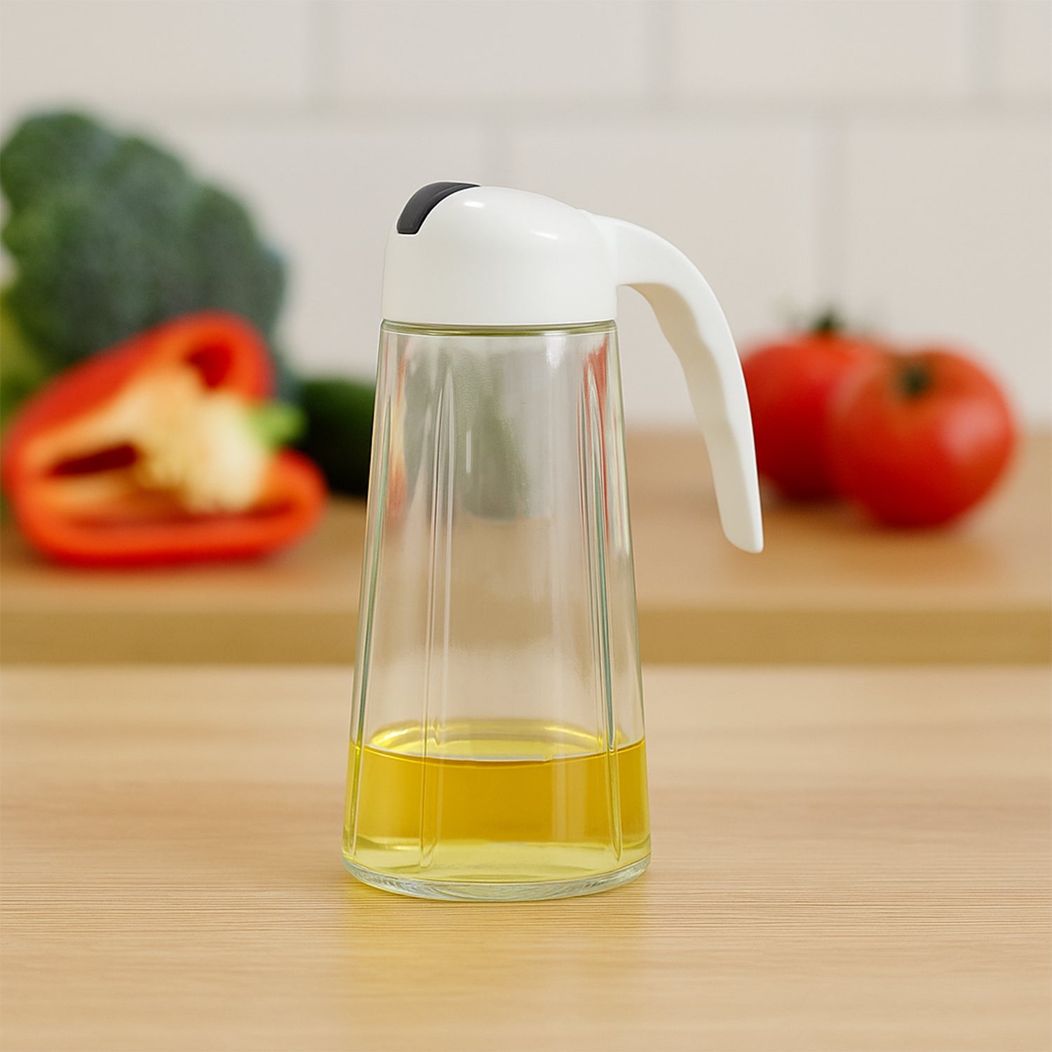 Glass oil bottle dispenser showing measuring marks and leak-proof spout