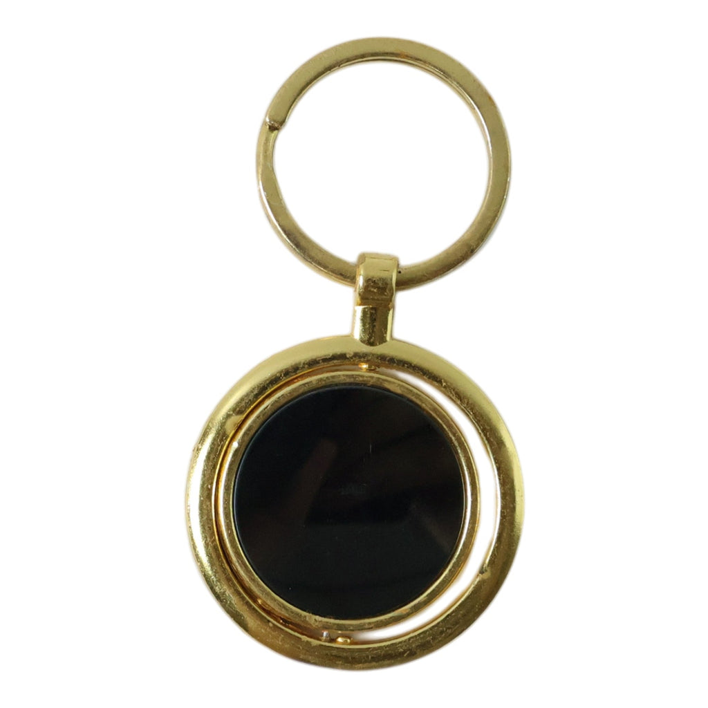 Modern gold plated keychain with black rotating pendant, ideal for gifting.