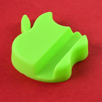 Multiple apple-shaped mobile phone stands arranged on a desk