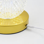 Rechargeable LED table lamp casting a warm glow on a bedside table.