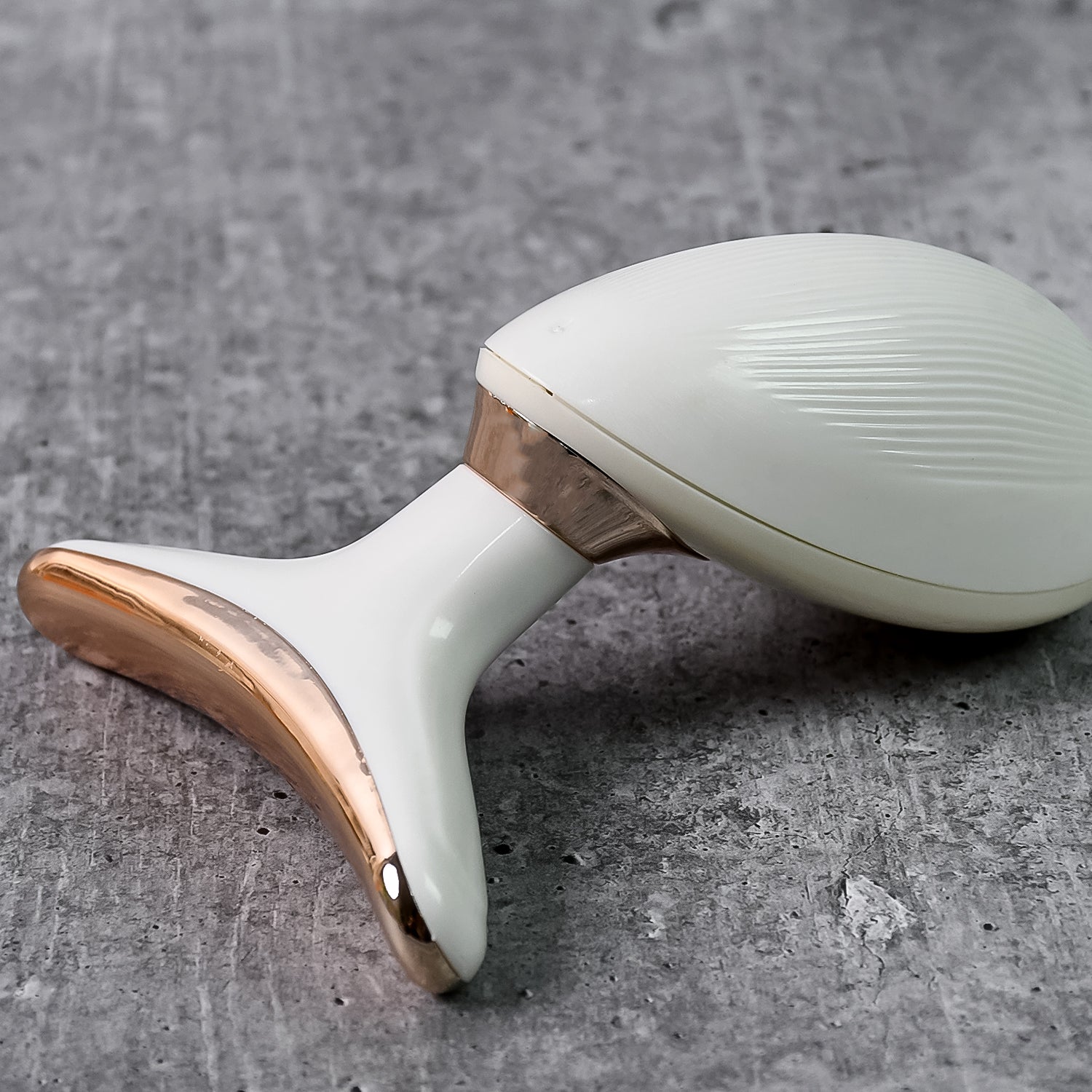 Top view of the Neck Face Massager's massage head and silver sensing rings.