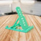 Sturdy plastic mobile phone stand with adjustable tilt in use