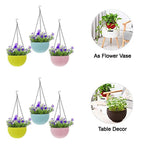 Hanging flower pots displayed outdoors on a fence, perfect for a garden decor combo.