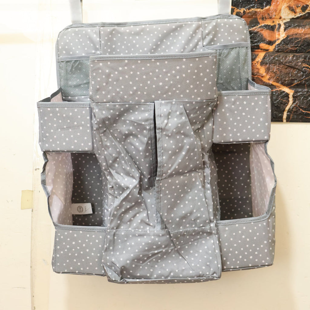 Side view of hanging baby care organizer with multiple pockets