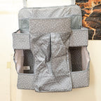 Side view of hanging baby care organizer with multiple pockets