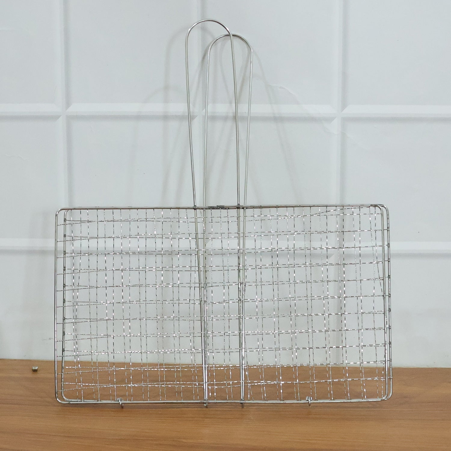 Heavy-duty stainless steel grill basket suitable for camping and picnics