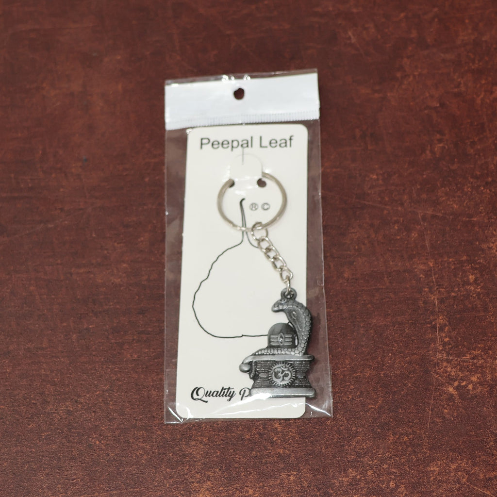 Display of durable metal Shivling keychain with snake design