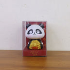 Multiple solar panda figurines in various poses, emphasizing their charm as car interior accessories.