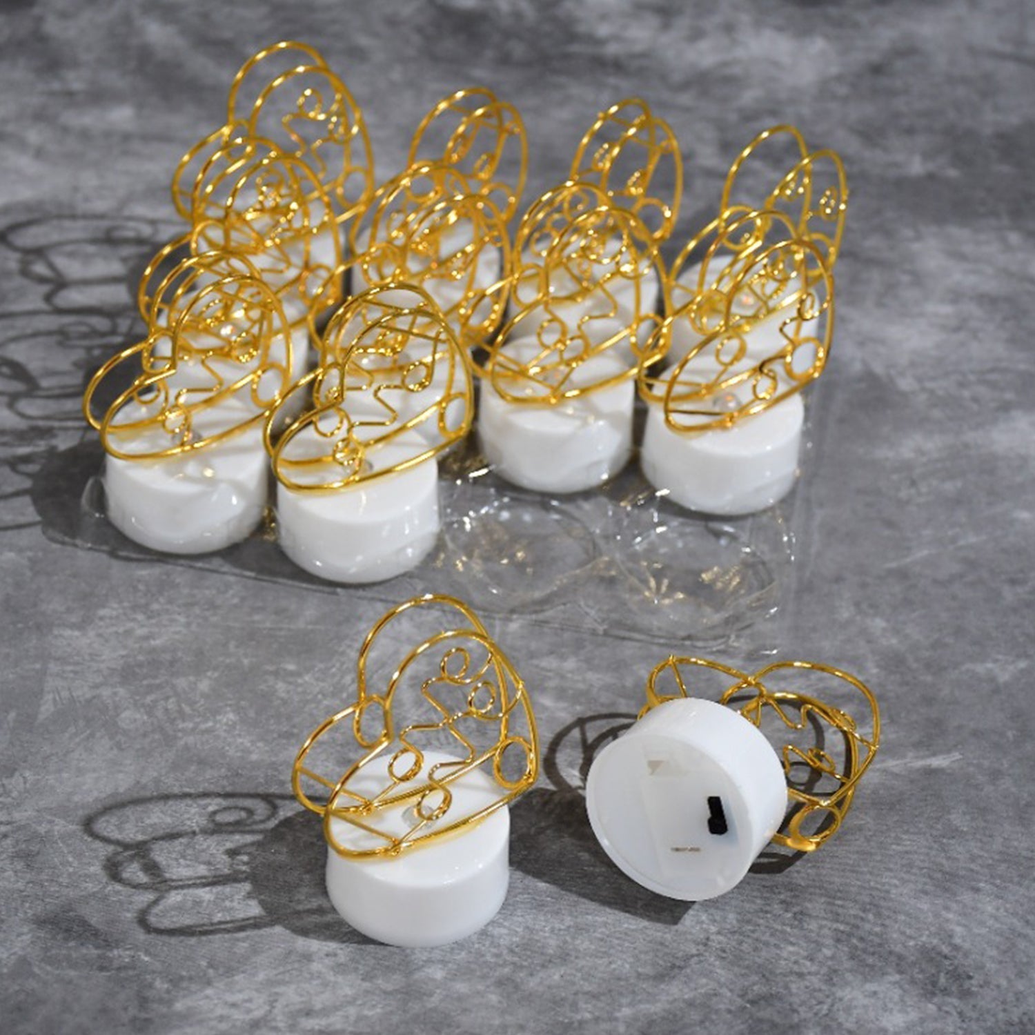 Multicolor flameless heart candles scattered on a surface, ideal for creating a festive or romantic setting.