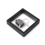 Nail clipper keychain attached to travel essentials with suitcase shape
