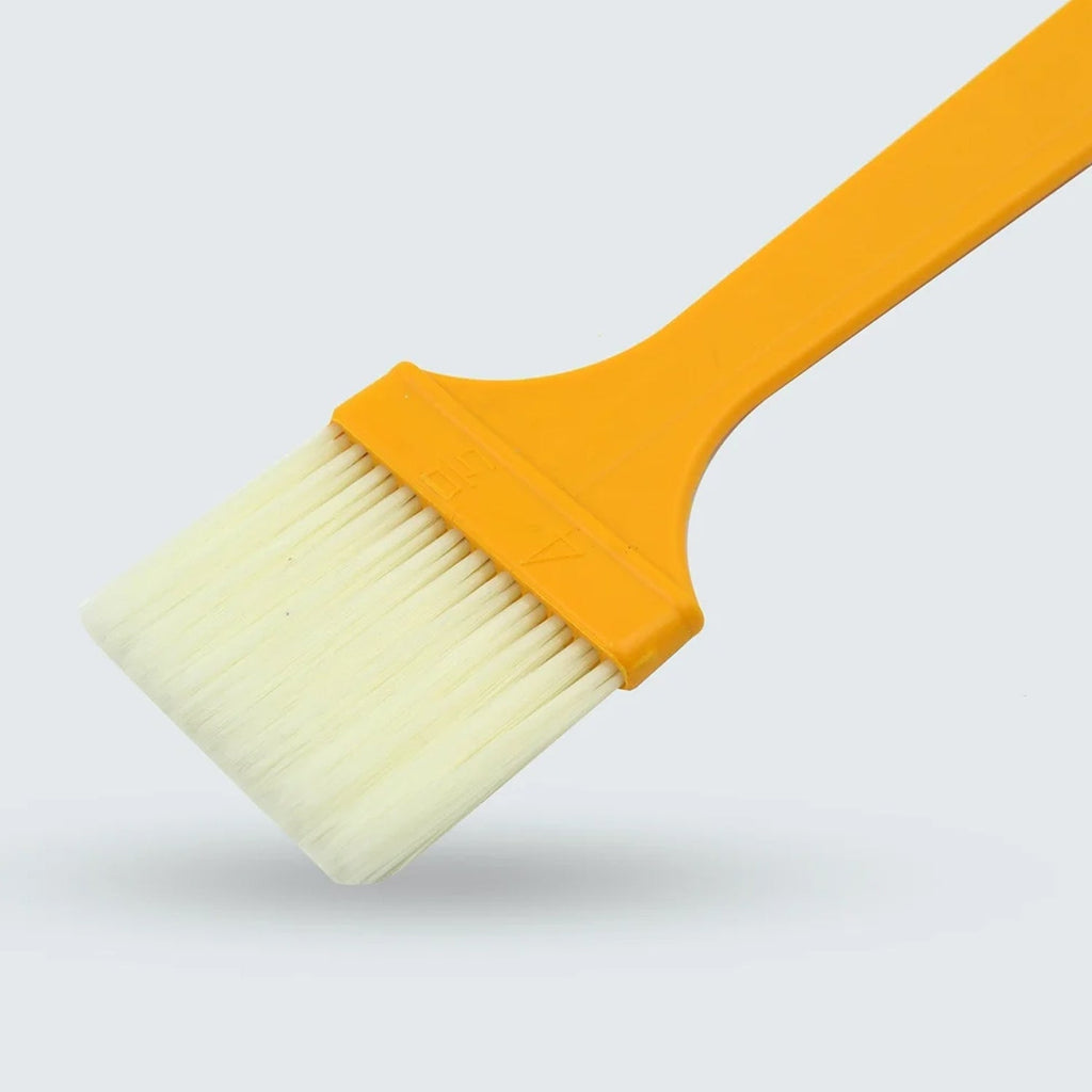 Silicone basting brush with ergonomic handle, ideal for applying oil or sauces.