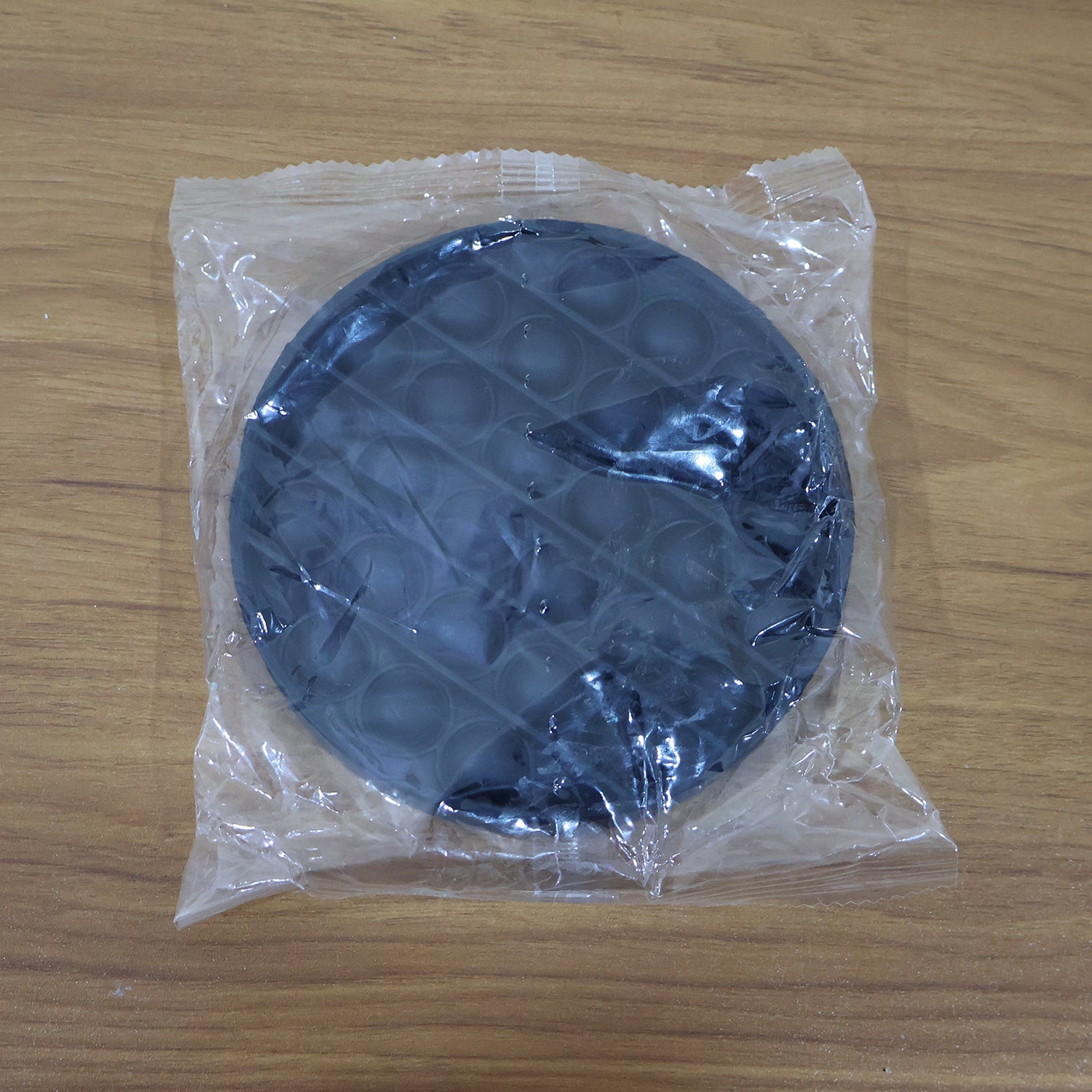 Back view of round silicone Pop It fidget toy for sensory play