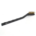 Brass wire brush laid flat, showcasing its compact size and design.