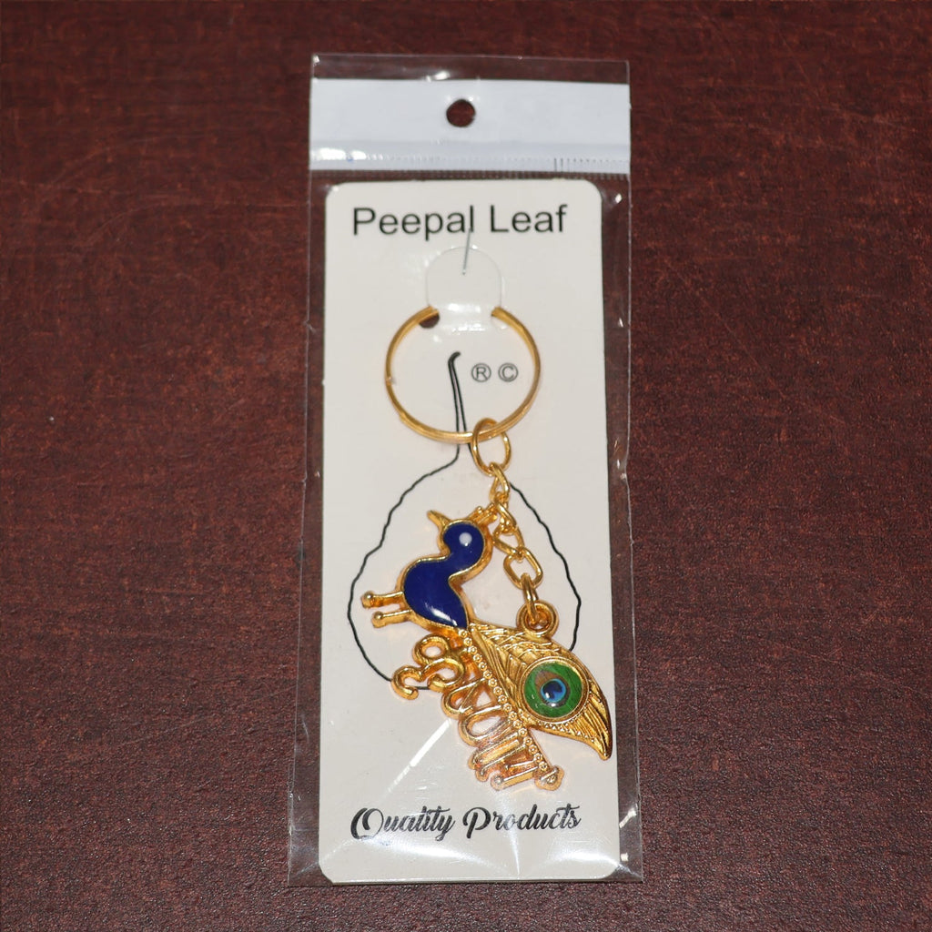 Golden Krishna Peacock keychain packaged in a Peepal Leaf blister pack