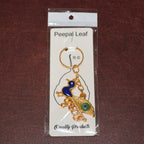 Golden Krishna Peacock keychain packaged in a Peepal Leaf blister pack