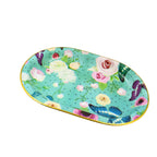 Large plastic serving tray with a detailed flower print design on a table.