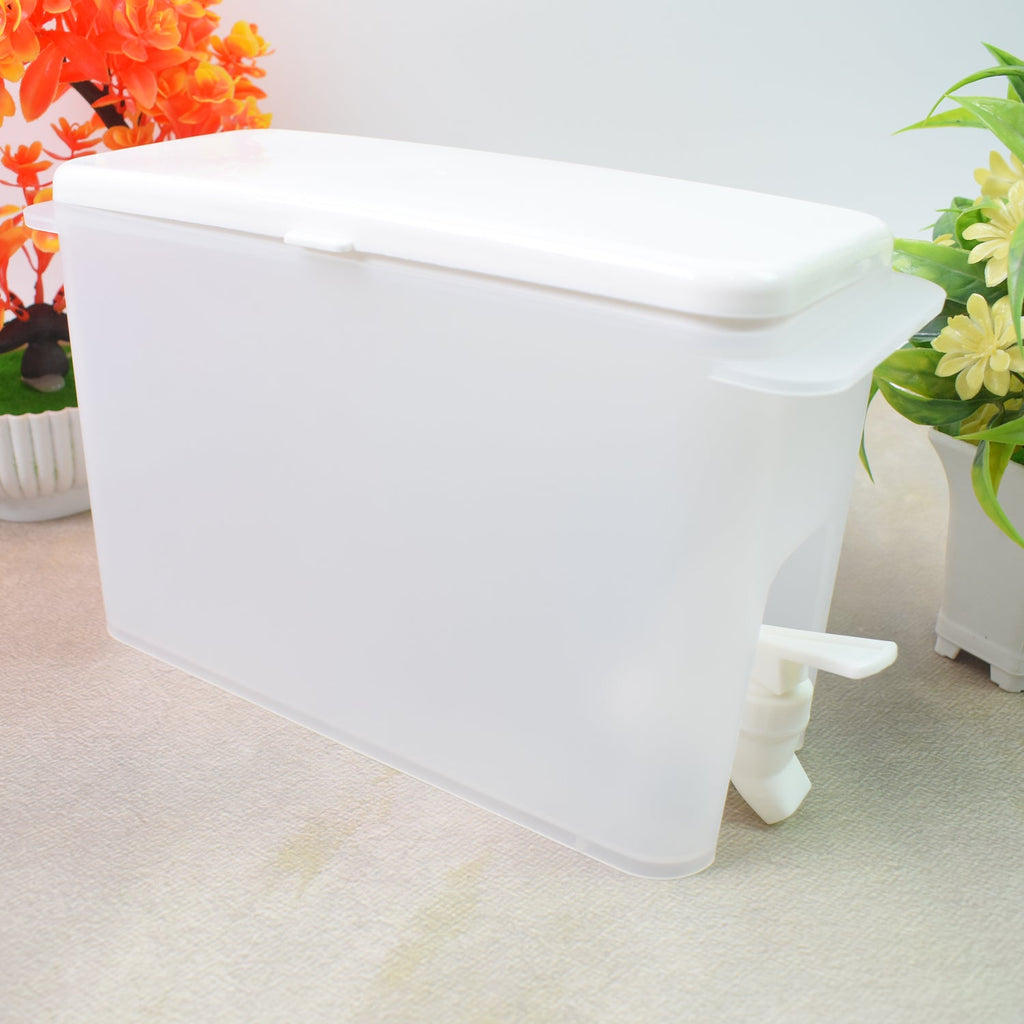 Slim water dispenser jug fitting perfectly inside a refrigerator, ready for use.
