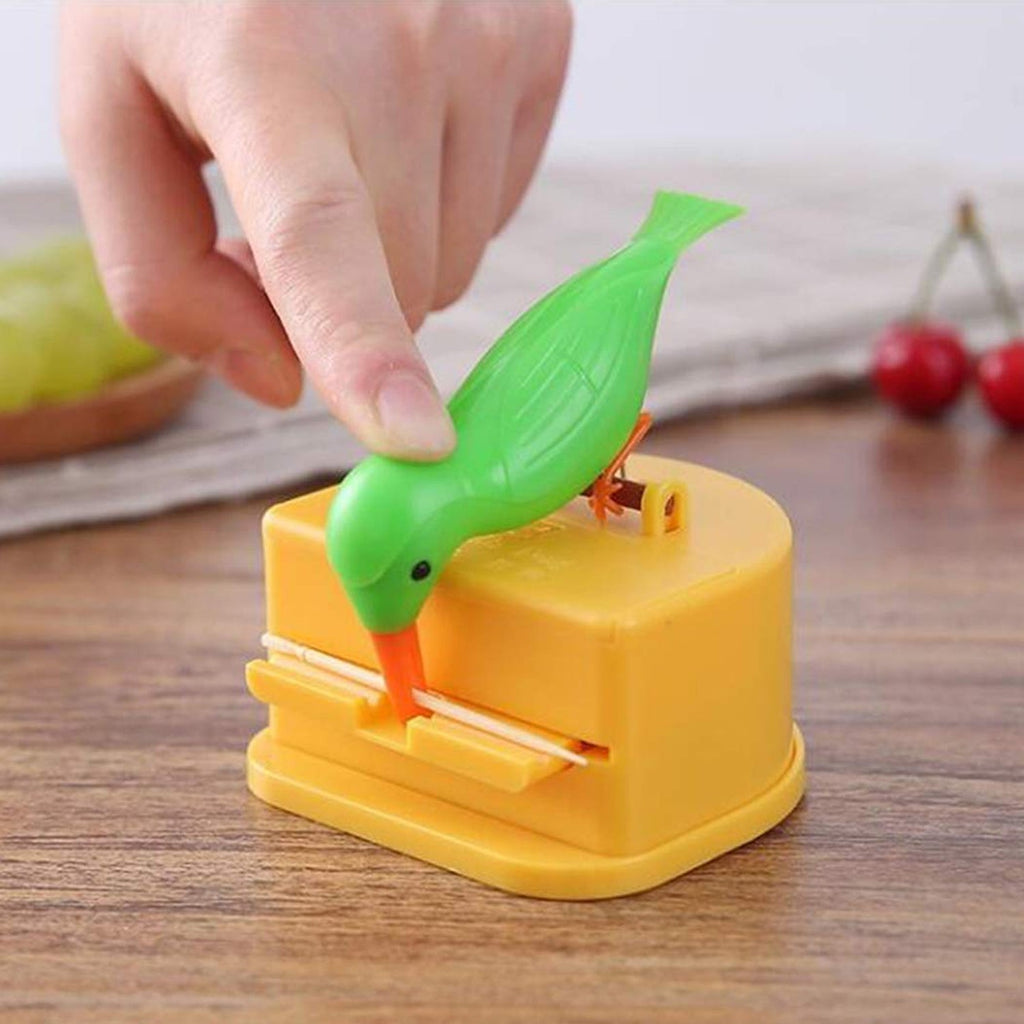 Demonstration of pressing button to dispense toothpick from bird dispenser