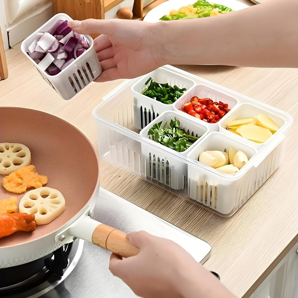 Fresh green vegetables like spinach and capsicum stored in a transparent fridge storage box.