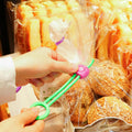Adjustable Food Bag Sealing Clip keeping a snack bag fresh on a kitchen counter.