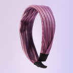 Dark ribbed knot hairband on white background showcasing textured fabric