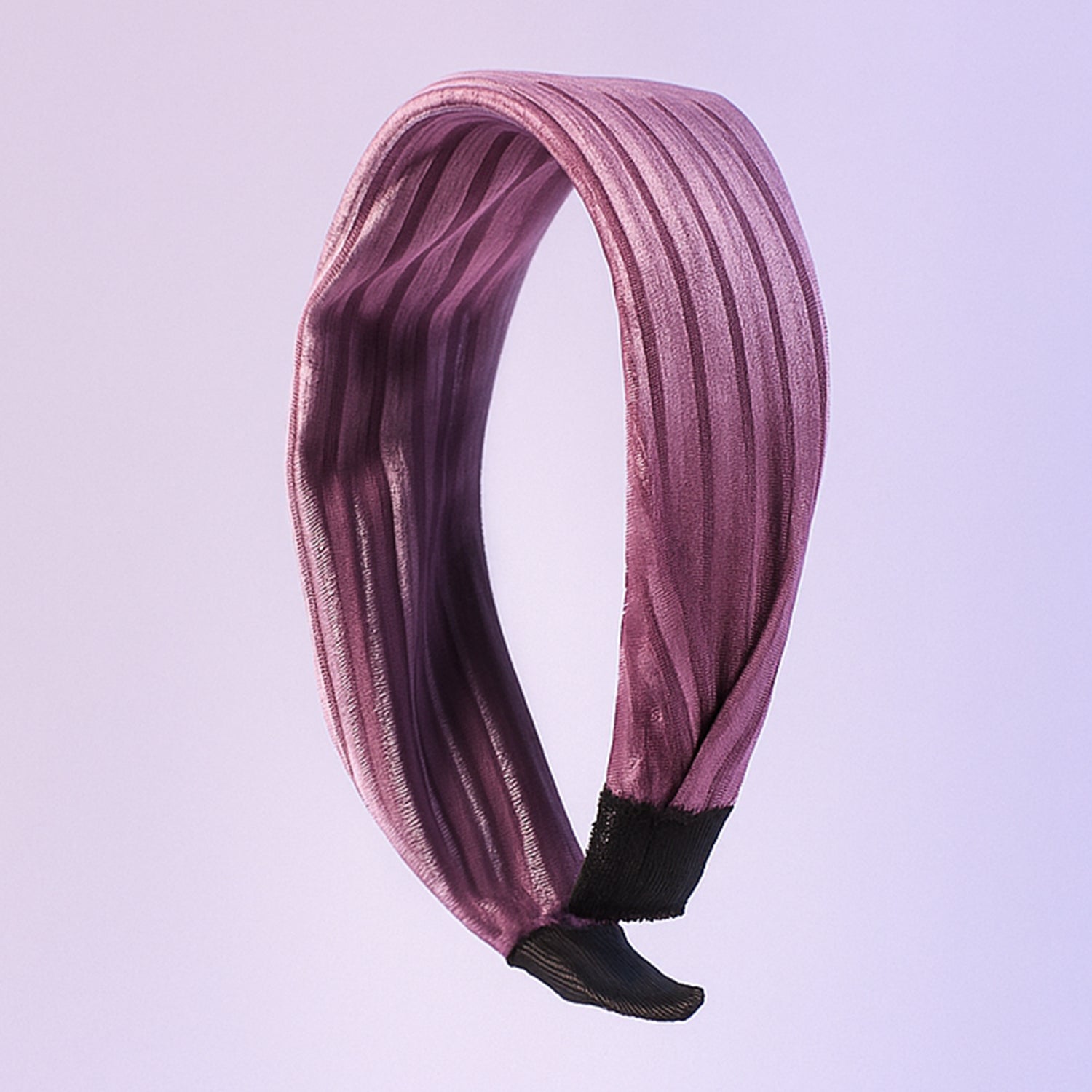 Dark ribbed knot hairband on white background showcasing textured fabric