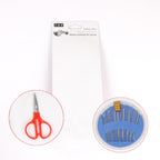 Compact sewing kit displaying assorted threads, needles, and a thimble.